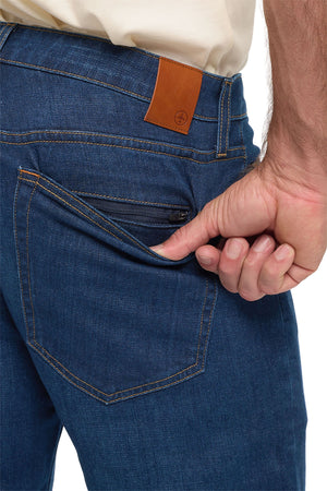 Men's vintage indigo travel jeans, close up of the back pocket and leather patch