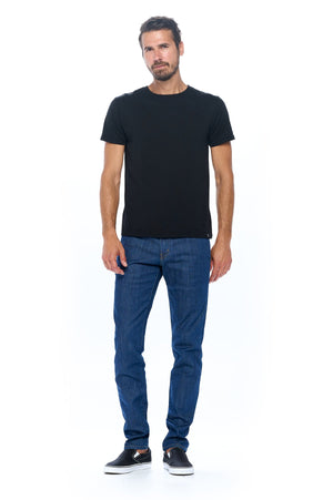Full view of a model wearing Aviator dark vintage travel jeans for men.