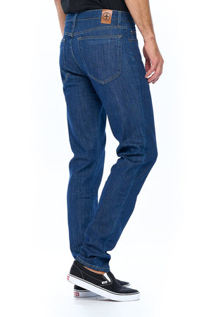 Back motion view of Aviator travel jeans for men in dark vintage color.