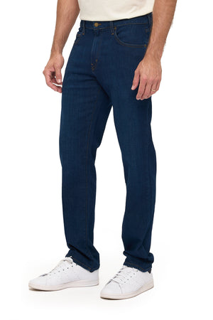 Men's dark indigo travel jeans, tailored fit, side profile view on model
