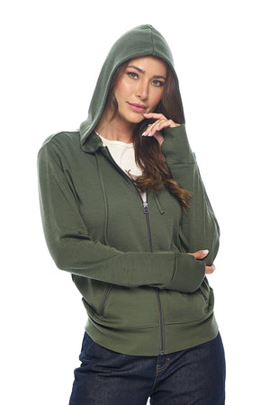 Model wearing the merino wool hoodie for travel in olive with the hood up.