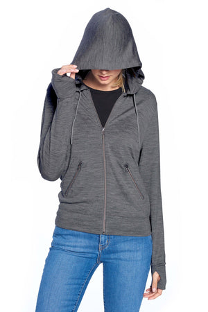 Model using the sleep mask hood on the women's merino wool travel hoodie in dark steel.