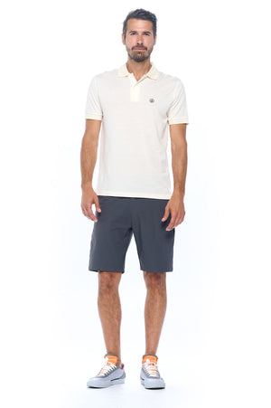 Model wearing an Aviator men's merino wool polo with the non stop travel shorts in grey.