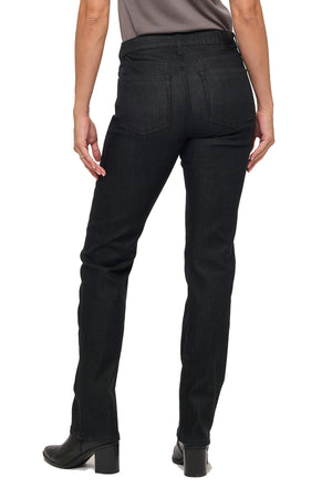 Back silhouette of the black denim jeans. Styled with a grey tucked in shirt and black booties.