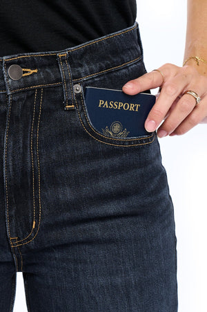 Showcasing deep front pockets of the midnight indigo travel jeans