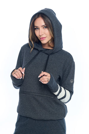 Model wearing a first class lounge travel hoodie with the hood up.