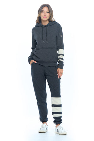 Full view of a female model wearing the first class lounge set with travel hoodie and travel pants.