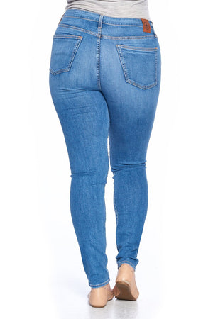 Back view of faded indigo travel jeans in comfort skinny