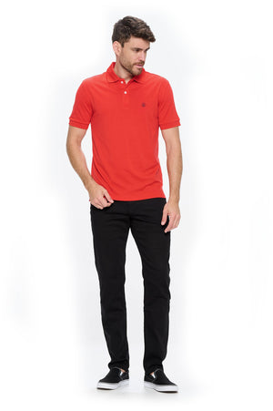Man wearing an Aviator merino wool polo for men and the jet black travel jeans for men