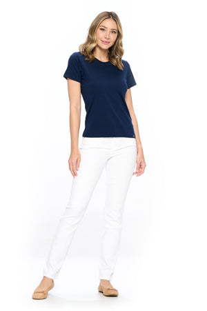 Model wearing the Aviator skinny travel jeans in white with a blue shirt top