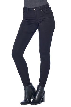 Side profile of model wearing Aviator travel jeans in skinny jet black