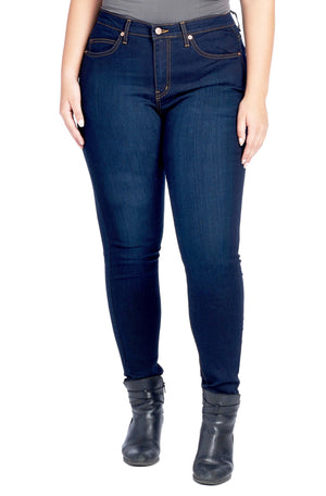 Model wearing larger size of dark indigo travel pants