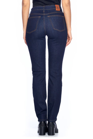 Back view of model wearing Aviator dark indigo travel jeans in a slim straight style