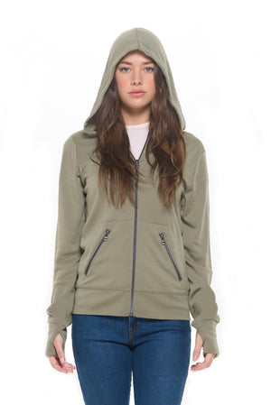 Model wearing the safari color merino wool travel hoodie for women with the hood up.