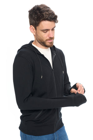 Model showing the built-in mitten on the merino wool travel hoodie by Aviator