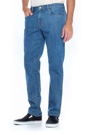 Side profile of model wearing the fly light travel jeans for men.