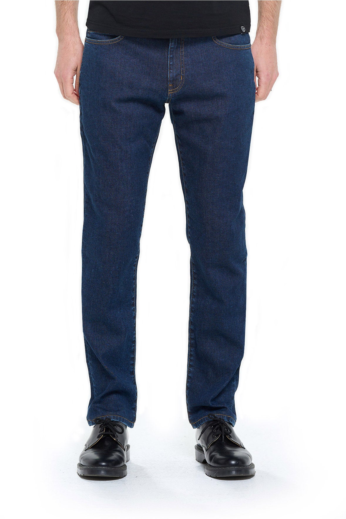 Model with a phone and passport in his Aviator Fly One Travel Jeans.