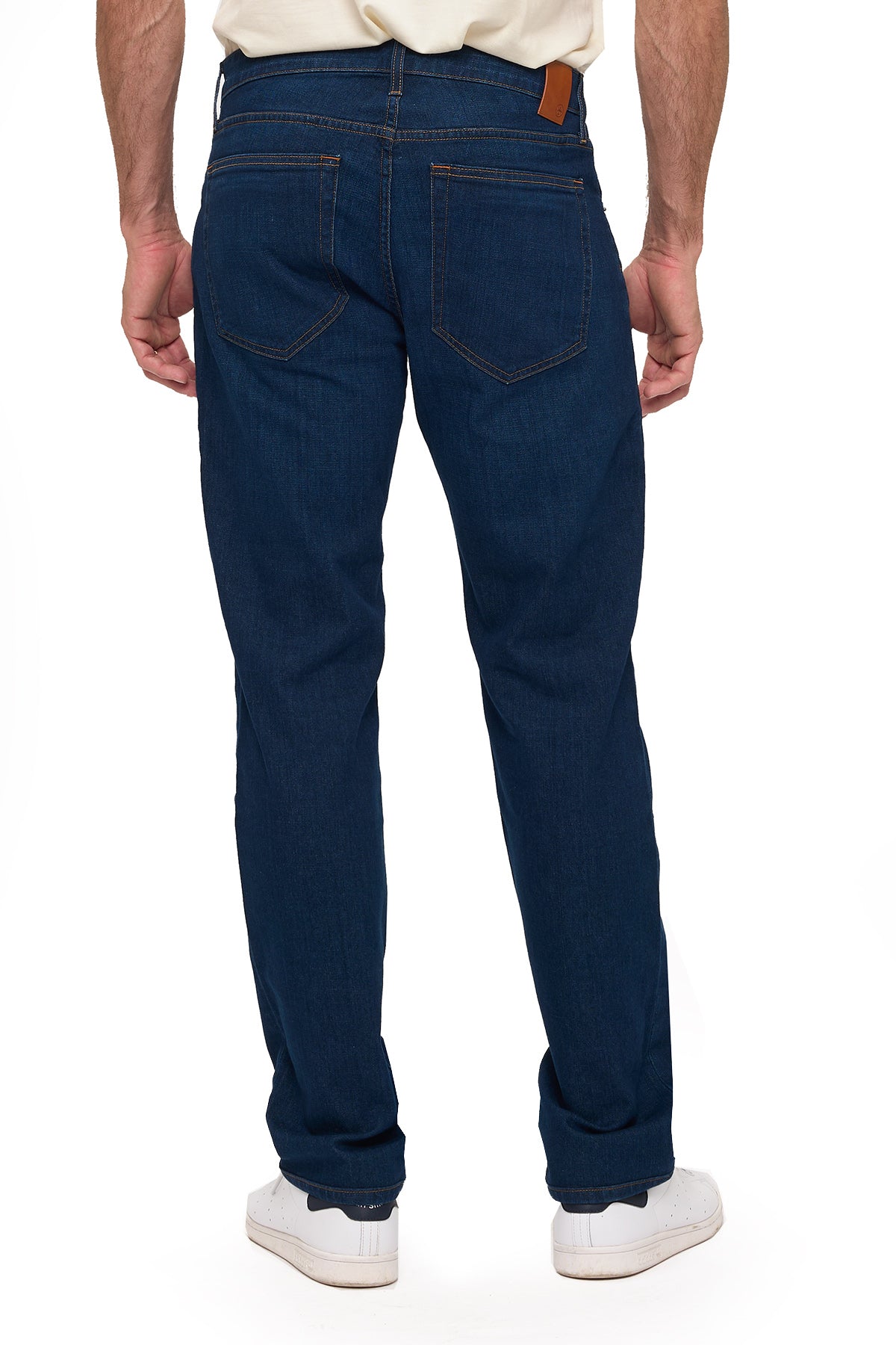 Men's dark indigo travel jeans, tailored fit, back view on model