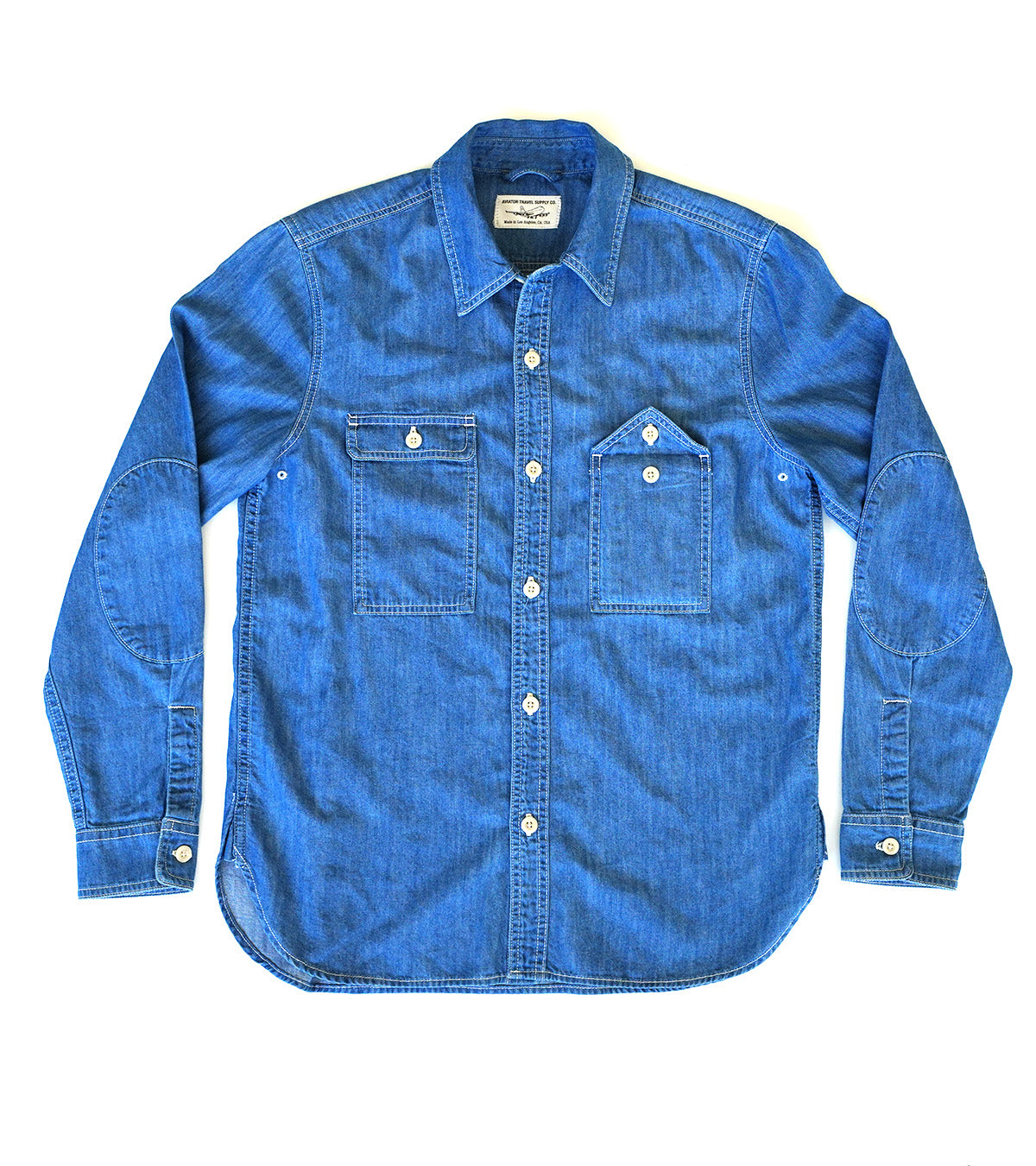 Stilllife of blue chambray shirt on a white background