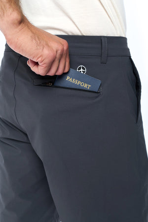 Model using the back hidden zipper pocket on the non stop travel shorts in grey.