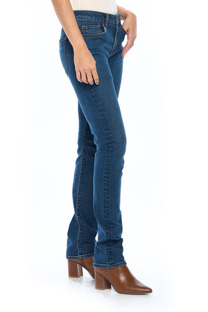 Side profile view of model posing wearing the fly straight vintage indigo travel jeans for women.