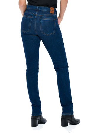 Back view of model wearing aviator women's travel pants in classic indigo