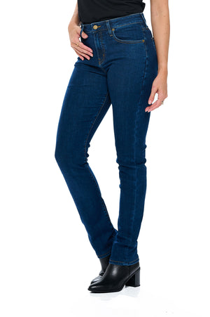 Side profile view of model wearing aviator women's travel jeans in classic indigo color slim straight style