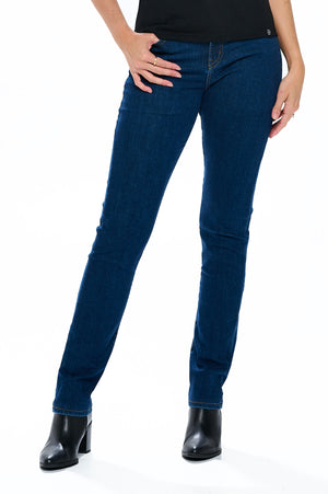 Model posing wearing aviator women's travel jeans in slim straight classic indigo