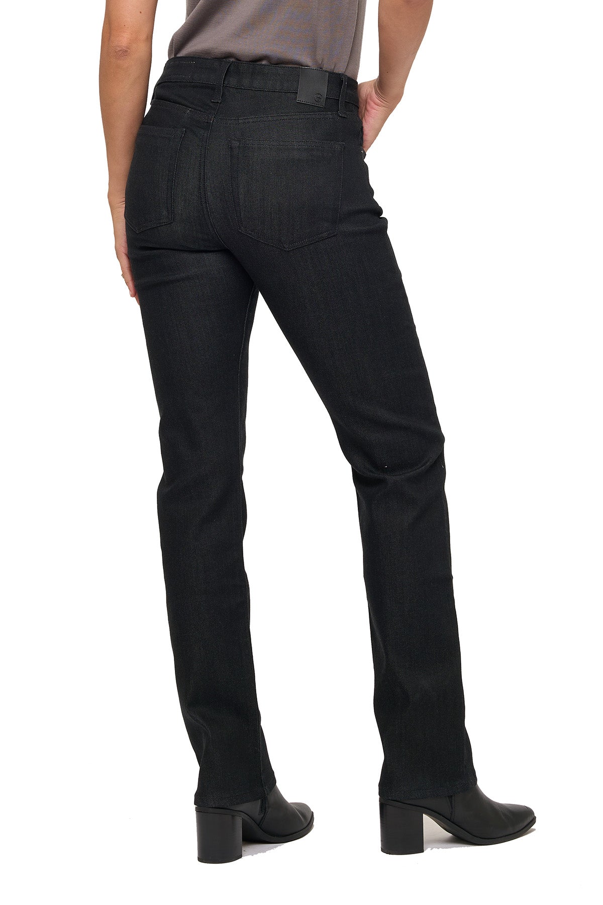 Model wearing black jeans on a white background