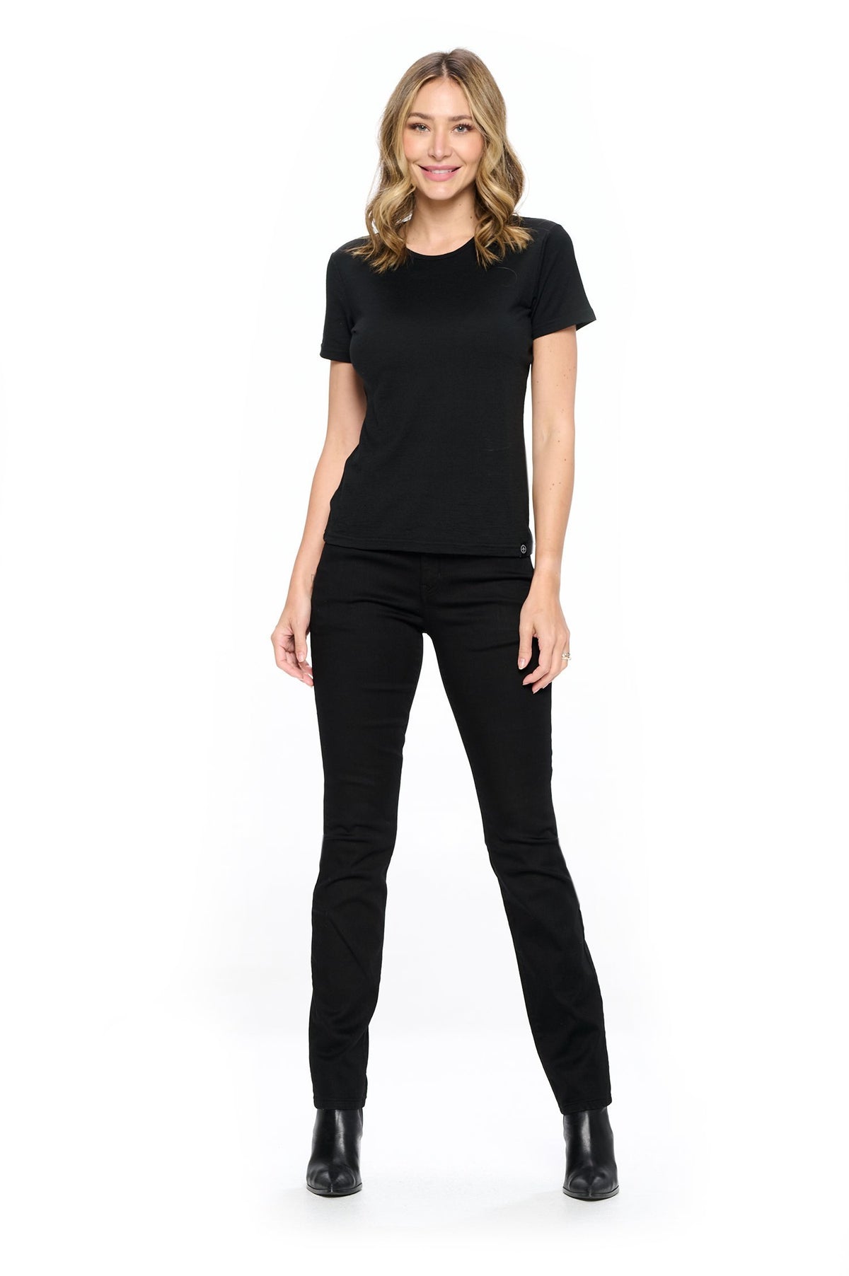 Full view of model wearing the jet black fly straight travel pants by Aviator.