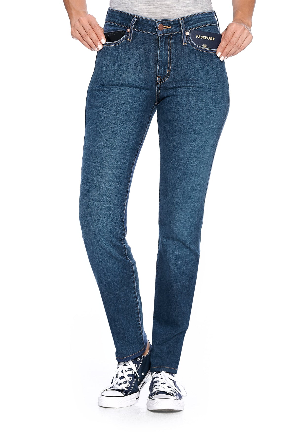 A model posing wearing the fly slim vintage indigo travel pants for women.